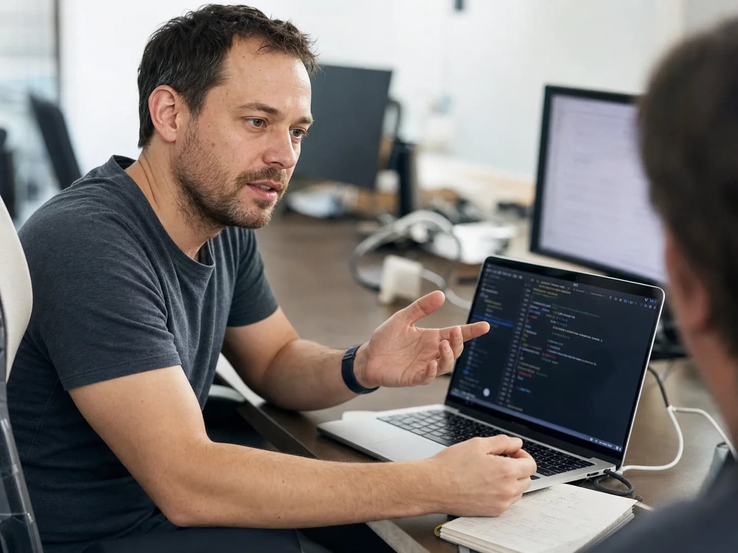 An everyday developer explaining an MCP connection at a shared desk